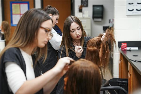 Cosmetology  students working on Mannequins 